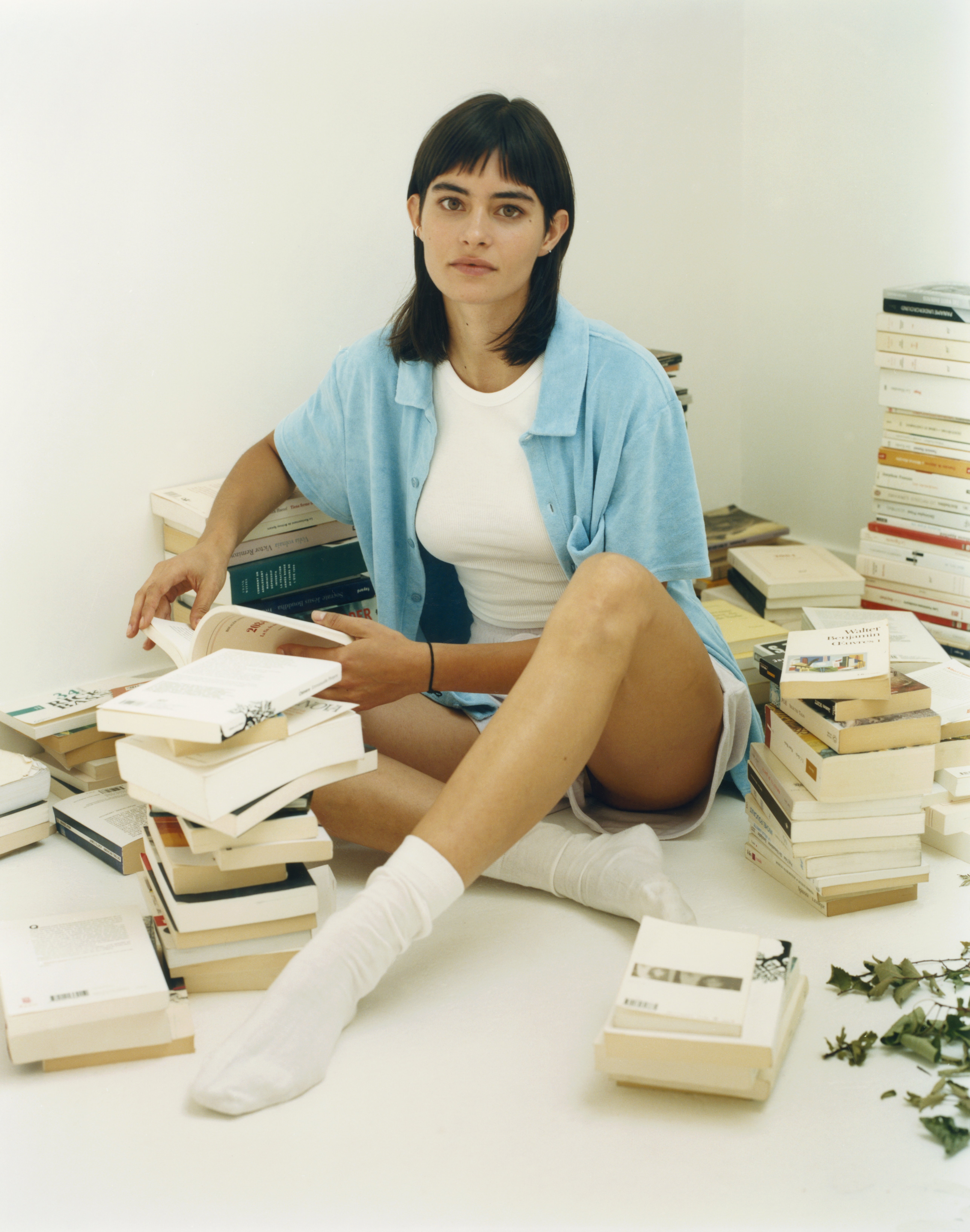 Woman sitting with books arround her